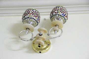 Closeup of a stylish, posh-looking bracket for holding two electrical lamps