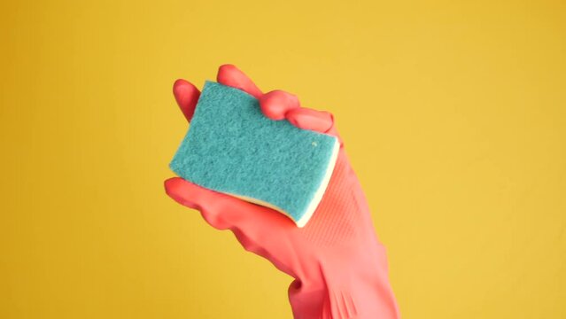  hand in a rubber gloves with a sponge 