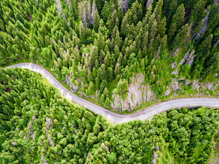 Winding road aerial view by drone. Sibiu, Romania. A great place to drive and stop during a road trip.