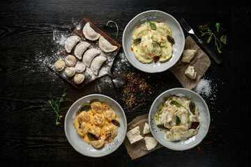 Preparation of raw ravioli with Mozzarella cheese and Tomato. Black background. Top view