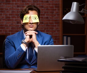 Young businessman working in the office at night