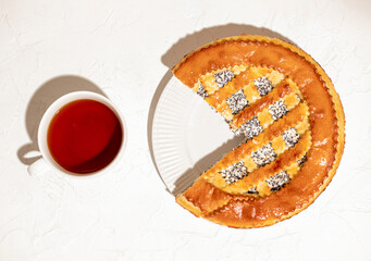 Homemade cake with cottage cheese and poppy seeds on a white table, top view