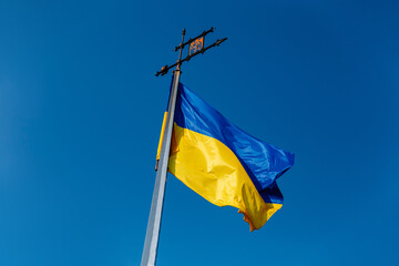 National Yellow-blue Ukrainian flag against the blue sky on mound of Union of Lublin at Castle Hill in Lviv city, Ukraine