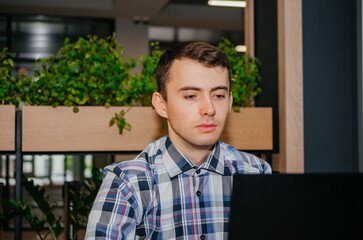 man sitting with a laptop in a cafe