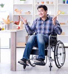 Disabled young man husband workin in kitchen