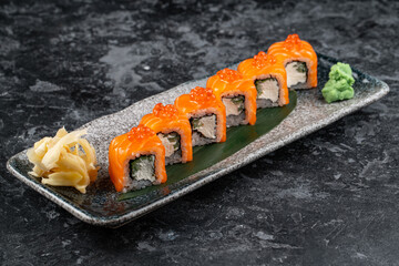 Sushi roll (Philadelphia) with salmon, smoked eel, avocado, cream cheese on black background. Sushi menu. Japanese food.