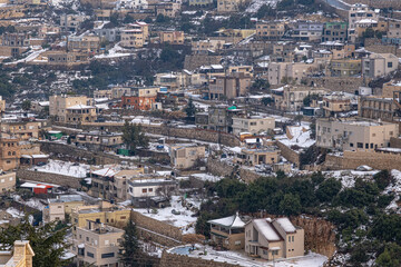Fototapeta na wymiar Winter view of the Druze village of Beit-Jann in snow, Mount Meron, Upper Galilee, Northern Israel, Israel. 