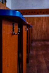 Selective focus shot of a small beg hanger attached to a wooden table