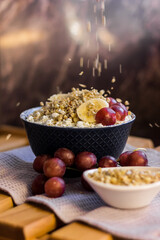A plate of cottage cheese with granola, muesli, oatmeal, grapes and banana. Protein diet breakfast. Healthy and delicious food for breakfast. High quality photo