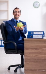 Young male accountant working in the office