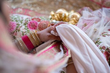Closeup of a bride's hands as she holds her veil in between them