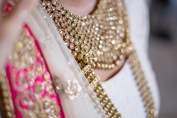 Closeup of a woman wearing beautiful traditional bridal jewelry at an Indian wedding