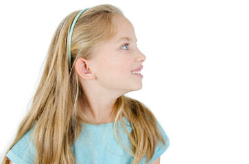 Profile or side view of adorable little girl looking on copy space. Isolated on white background