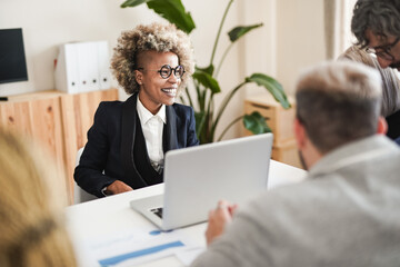 Happy multiracial business people working inside modern office using computer laptop