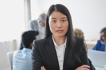 Portrait of young asian business woman looking on camera - Multiracial business people working inside modern office