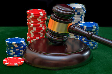 Judicial gavel and casino chips. Jurisprudence and gambling concept. Poker chips. Casino tokens,...