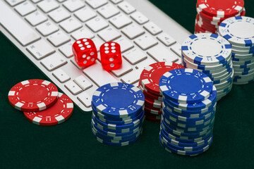 Gambling online casino Internet betting concept. Jackpot, casino chips. computer keyboard, laptop with poker chips, dice. Casino tokens, gaming chips, checks, or cheques