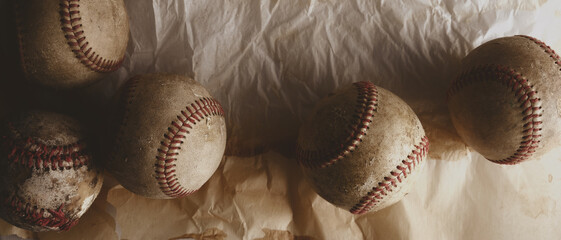 Baseball sport background with old vintage used game balls on texture backdrop.