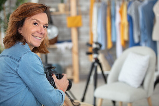 mature female photographer taking pictures with dslr camera