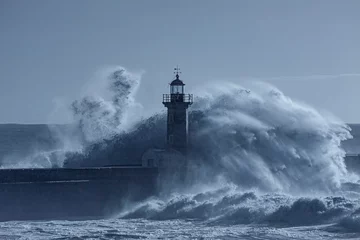 Foto op Canvas Lighthouse in the middle of stormy waves © Zacarias da Mata