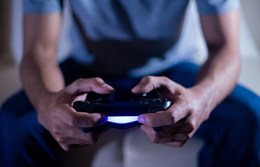 close up hand of young man playing video game holding controller © Near
