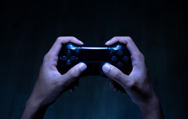 close up hand of young man playing video game holding controller