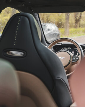 Aston Martin DBX SUV interior view cockpit, steering wheel and buttons details