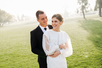 Amazing smiling wedding couple. Satisfied bride and stylish groom.