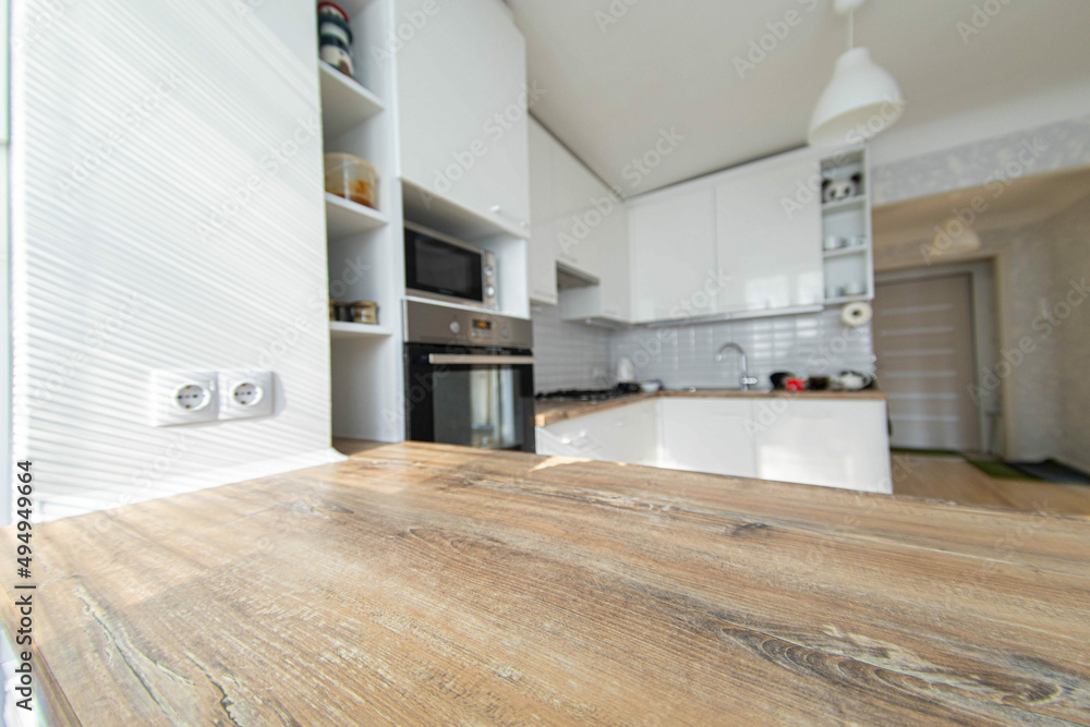 Wall mural wooden table on the background of the kitchen