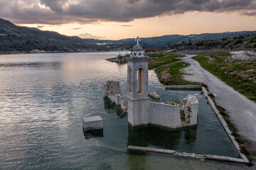 Fototapeta na wymiar Ruined old church in Alassa, Cyprus is submerged under water of Kouris dam, photographed from drone