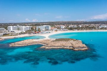 Obraz na płótnie Canvas Nissi Beach in Ayia Napa, clean aerial photo of famous tourist beach in Cyprus, the place is a known destination on island and is formed from a smaller island just near the main shore