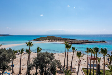 Fototapeta na wymiar Nissi Beach in Ayia Napa, clean aerial photo of famous tourist beach in Cyprus, the place is a known destination on island and is formed from a smaller island just near the main shore