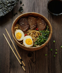 chinese food on a plate with chopsticks