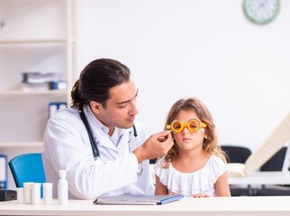 Young doctor pediatrician with small girl