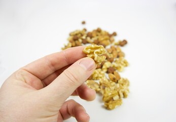 Picking up a piece of walnut with fingers