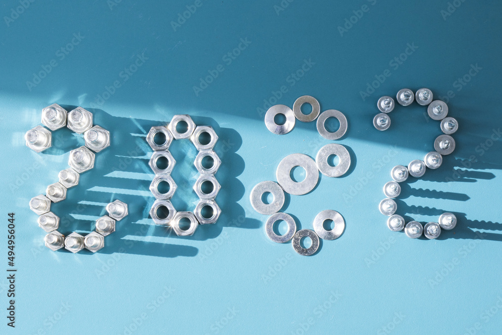Poster new year background design with 2022 written with bolts and nuts