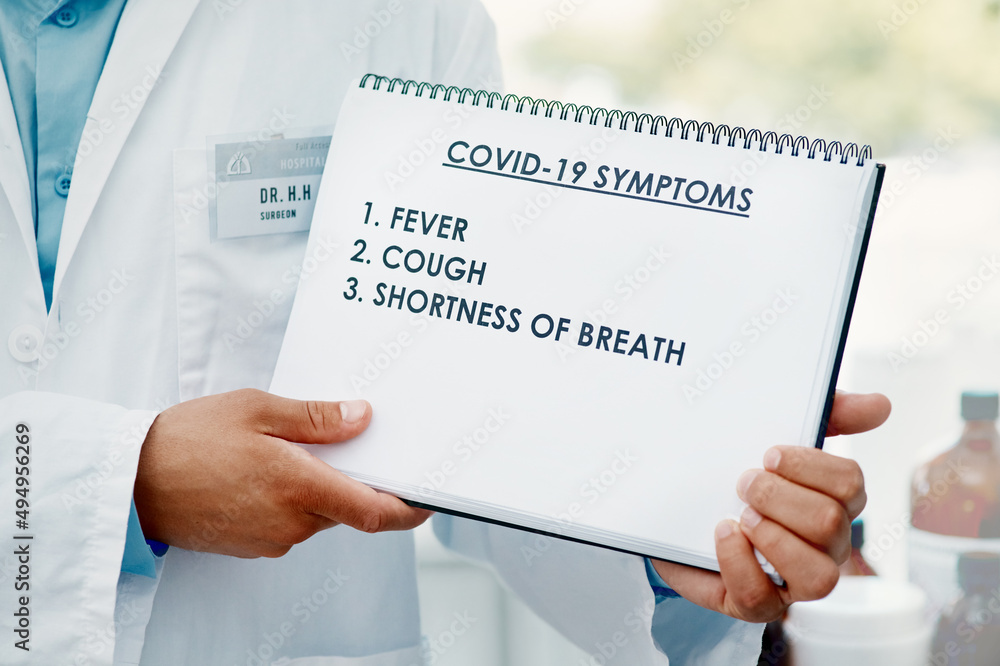 Poster stay alert, stay safe. cropped shot of a scientist holding a sign with a list of covid-19 symptoms o