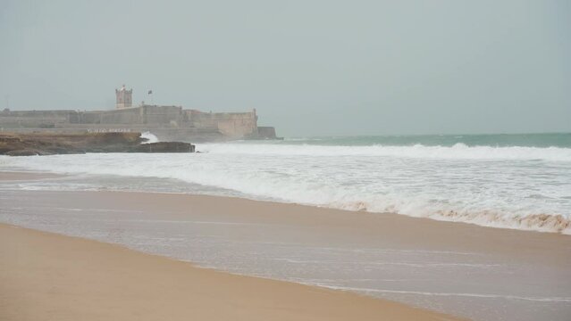 Carcavelos beach and Saint Julian fortress at spring before rain and storm 