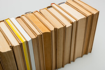 high angle view of row of books on grey background.