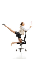 Portrait of young flexible woman in business style clothes with folder making twine isolated over white studio background