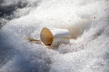 White paper cup in the snow.