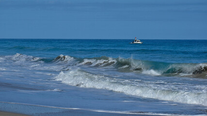 A small boat fighting rough surf off the coast of Florida