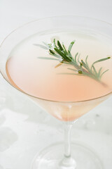 Close-up of grapefruit cocktail with a  rosemary