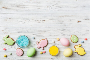 holiday preparation Multi colors Easter eggs with cookies on colored background . Pastel color Easter eggs. holiday concept with copy space