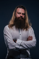 Close up portrait of handsome manly guy with beard posing in studio on a isolated background.