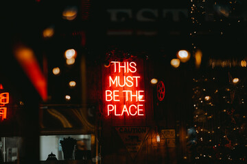 Neon sign of this must be the place © Mike Grabarek/Wirestock Creators
