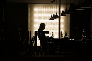 Silhouette of the man sitting in the cafe.