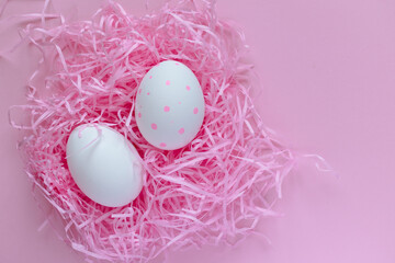 Easter layout. White eggs in a pink nest on a pink background. Bright Easter. Celebration. Postcard. place for text