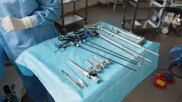 Preparation for surgery. The surgeon and the surgical equipment in the operating room are preparing the surgical instruments that are sterile for the doctor in the surgery. Surgeon an instrument