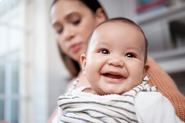 He just gets cuter by the day. Shot of an adorable baby bonding with his mother at home.